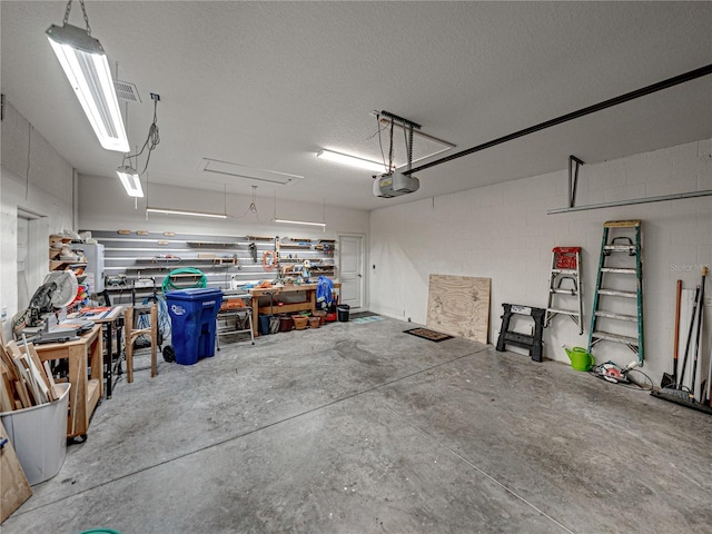 garage featuring a garage door opener and a workshop area