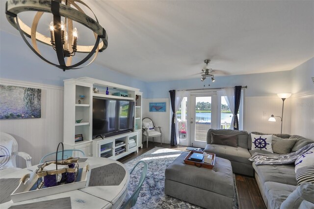 living room featuring dark hardwood / wood-style flooring and ceiling fan with notable chandelier