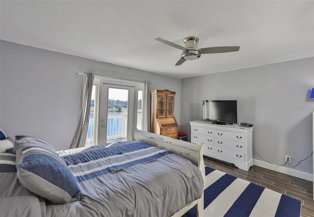 bedroom with ceiling fan, access to exterior, and dark hardwood / wood-style floors