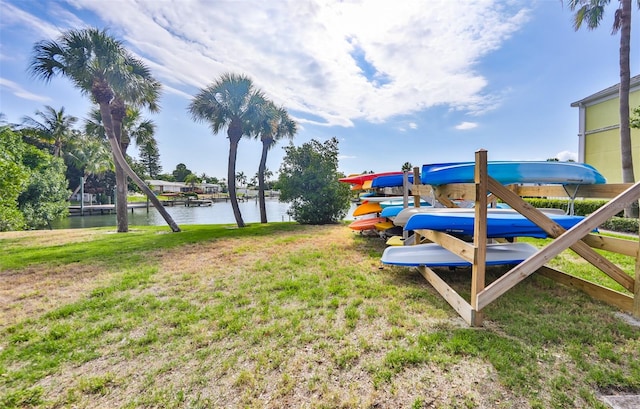 view of yard featuring a dock and a water view