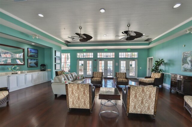 living room featuring ceiling fan, ornamental molding, and dark hardwood / wood-style floors