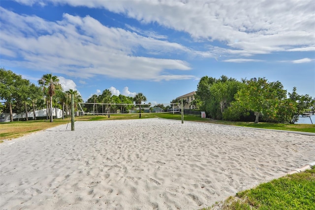 view of community with a yard and volleyball court