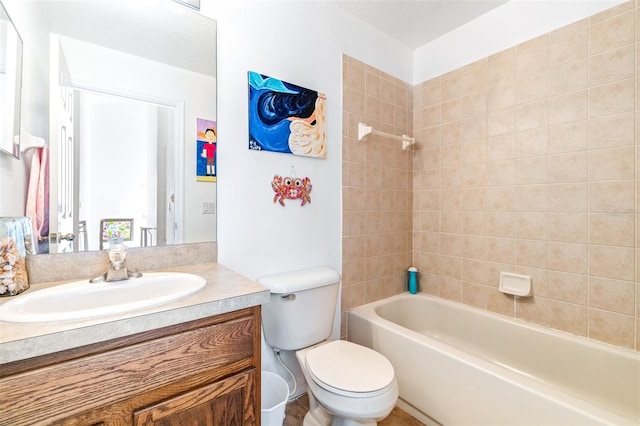 full bathroom featuring toilet, tiled shower / bath combo, and vanity