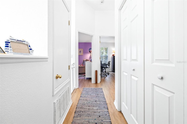 corridor with light hardwood / wood-style flooring