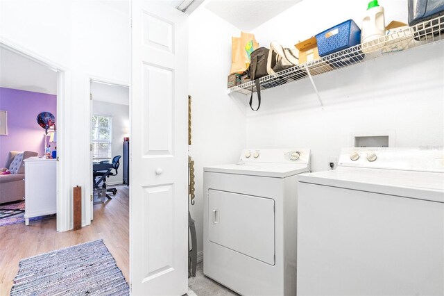 washroom with light hardwood / wood-style flooring and separate washer and dryer