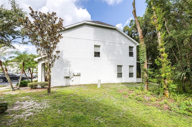 view of property exterior featuring a lawn