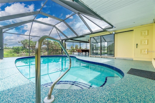 view of swimming pool featuring glass enclosure and a patio