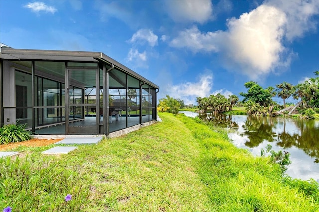 view of yard featuring a pool and a water view