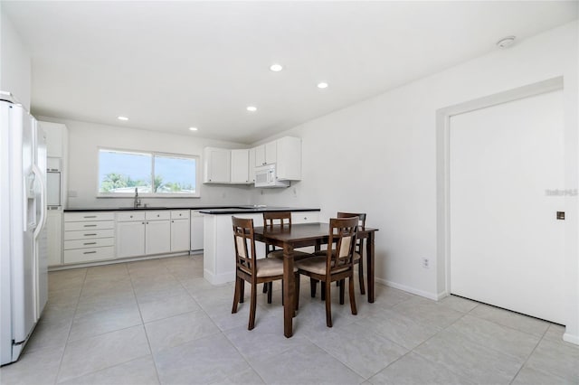 dining area featuring light tile patterned floors and sink