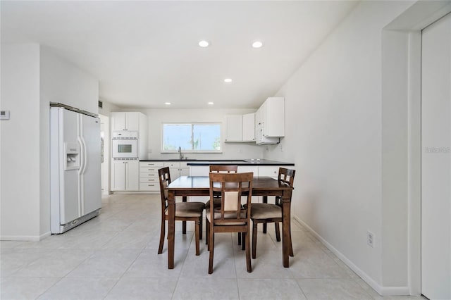 tiled dining space featuring sink