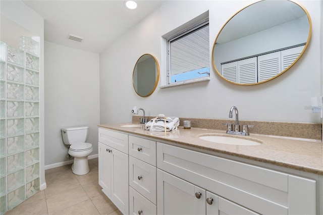 bathroom featuring tile patterned flooring, toilet, and vanity