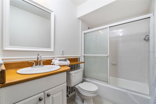 full bathroom featuring toilet, combined bath / shower with glass door, tile patterned flooring, and vanity