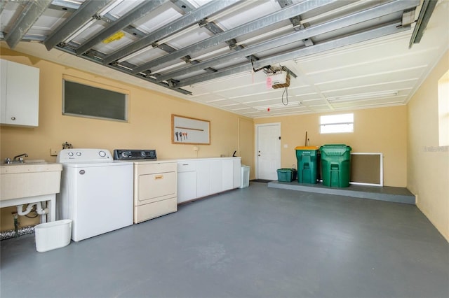 garage featuring a garage door opener and separate washer and dryer