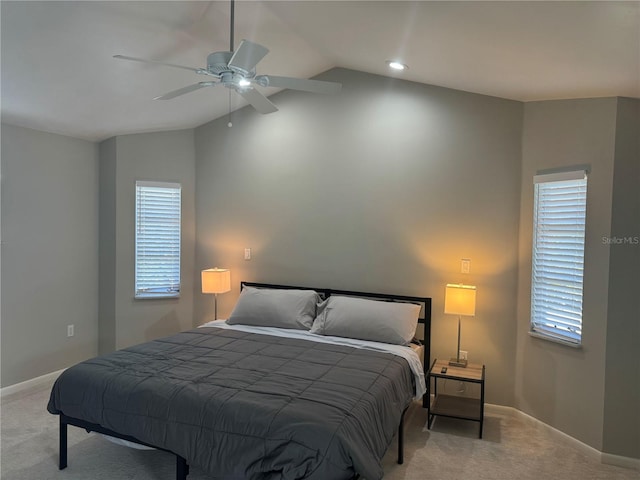 carpeted bedroom featuring ceiling fan, lofted ceiling, and multiple windows