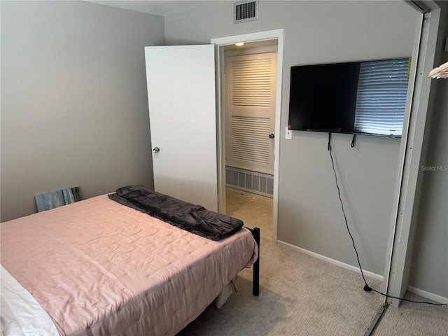 bedroom featuring light carpet