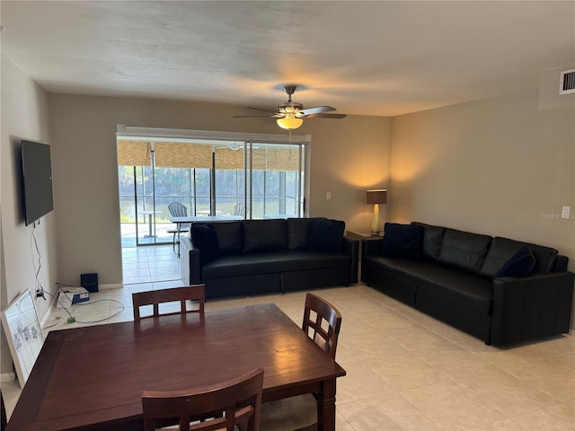 living room featuring ceiling fan and light tile patterned flooring