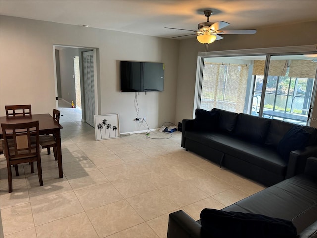 tiled living room with ceiling fan