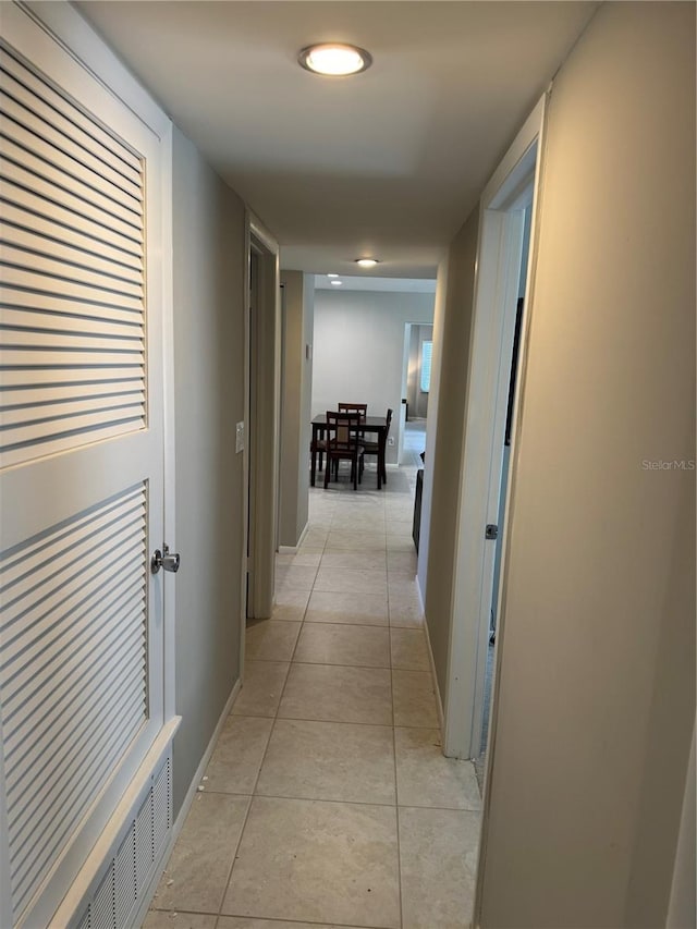 hall featuring light tile patterned flooring