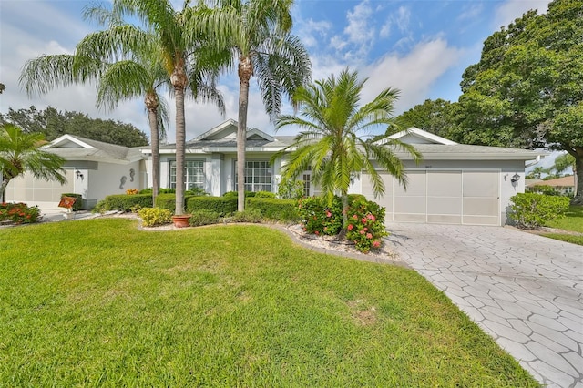 ranch-style home with a garage and a front lawn