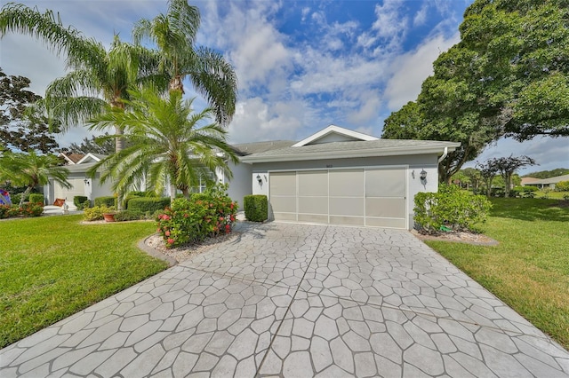 902 Mcdaniel St Unit 1, Sun City Center, FL 33573 - ranch-style house with a garage, driveway, a front yard, and stucco siding