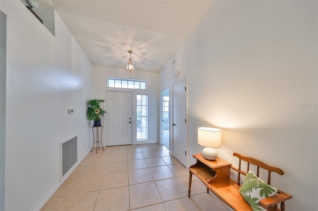 902 Mcdaniel St Unit 1, Sun City Center, FL 33573 - foyer with light tile patterned floors and baseboards