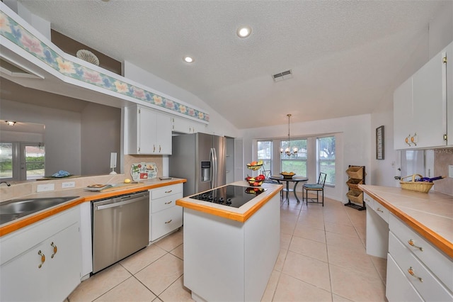 902 Mcdaniel St Unit 1, Sun City Center, FL 33573 - kitchen with appliances with stainless steel finishes, lofted ceiling, white cabinets, a chandelier, and a sink