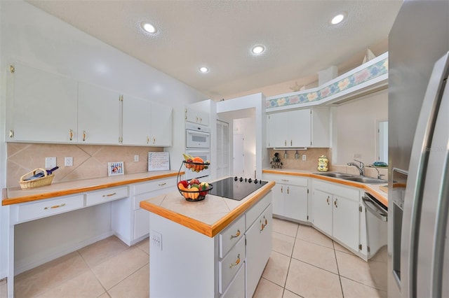 902 Mcdaniel St Unit 1, Sun City Center, FL 33573 - kitchen featuring a sink, light countertops, stainless steel appliances, backsplash, and light tile patterned floors