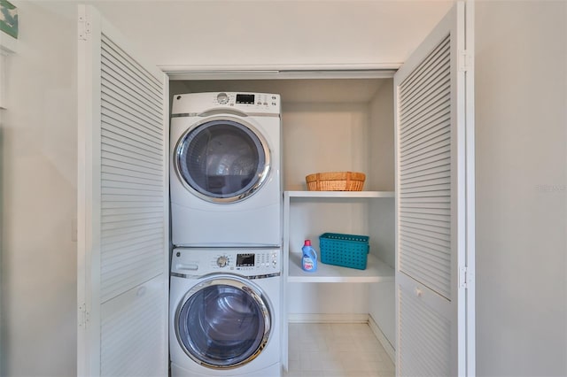 clothes washing area featuring stacked washer / drying machine