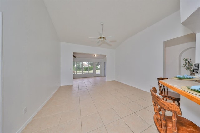 902 Mcdaniel St Unit 1, Sun City Center, FL 33573 - dining room with vaulted ceiling, a ceiling fan, light tile patterned floors, and baseboards