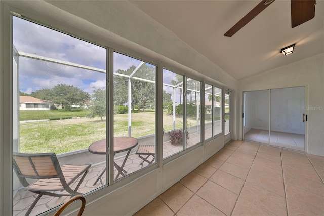 unfurnished sunroom featuring vaulted ceiling and ceiling fan