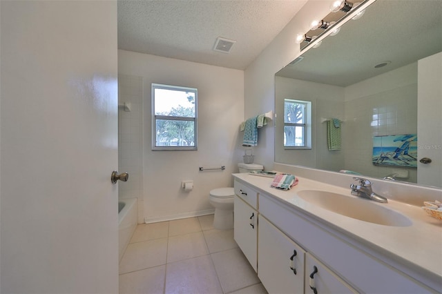 full bathroom with vanity, a textured ceiling, toilet, and tile patterned floors