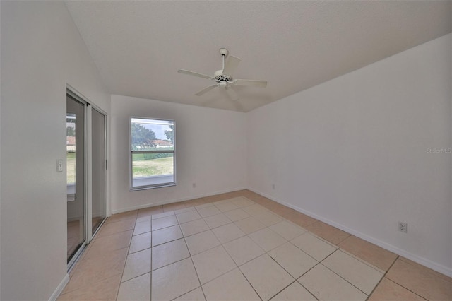 tiled empty room with a textured ceiling and ceiling fan