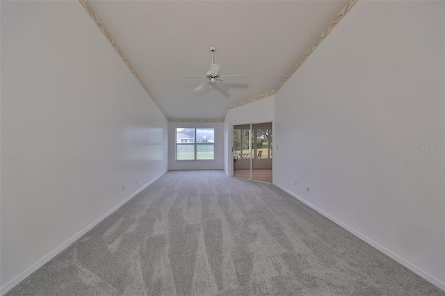 carpeted spare room featuring ceiling fan and lofted ceiling