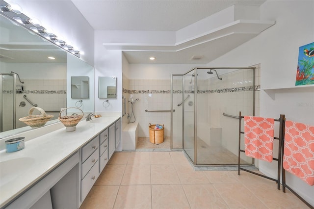 902 Mcdaniel St Unit 1, Sun City Center, FL 33573 - bathroom featuring tile patterned flooring, double vanity, a shower stall, and a tub to relax in
