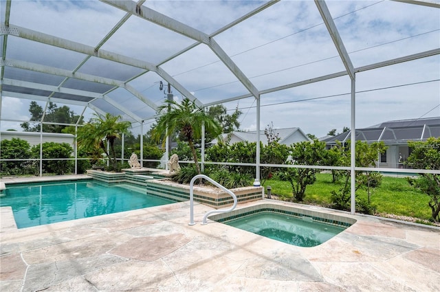 view of pool with a lanai, an in ground hot tub, and a patio area