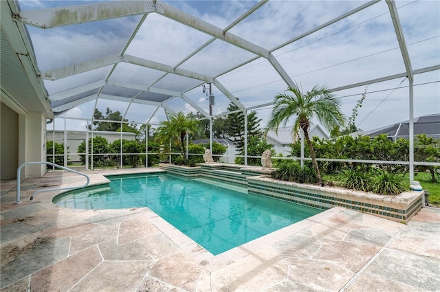 view of swimming pool featuring a lanai and a patio area