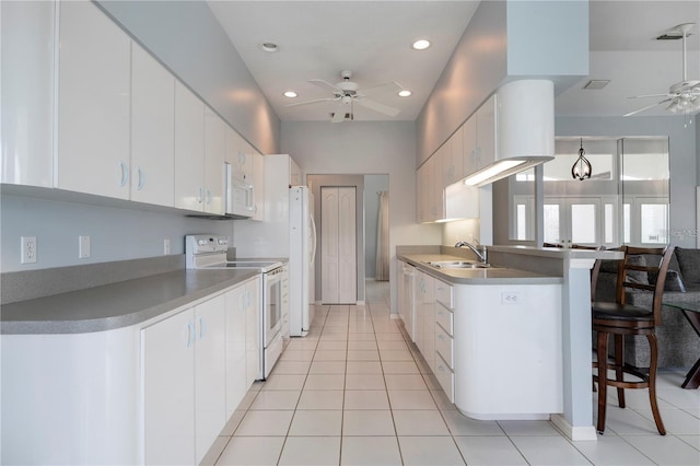 kitchen featuring white appliances, ceiling fan, and white cabinetry