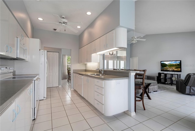 kitchen featuring light tile patterned floors, high vaulted ceiling, white appliances, ceiling fan, and white cabinets