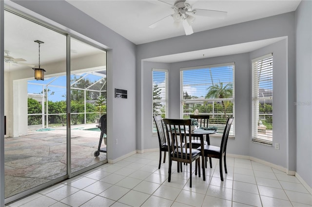 tiled dining area featuring ceiling fan and a healthy amount of sunlight