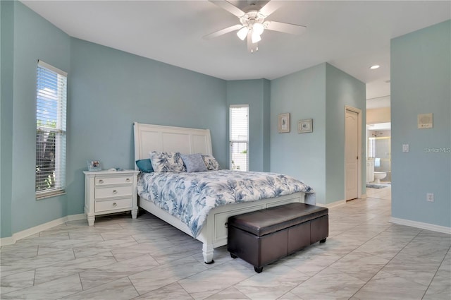 tiled bedroom featuring ceiling fan and connected bathroom