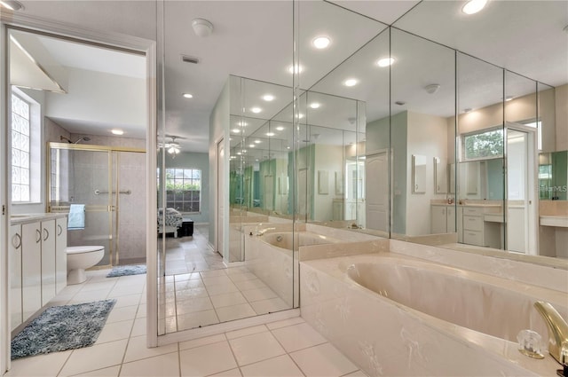 full bathroom featuring tile patterned floors, vanity, shower with separate bathtub, and toilet