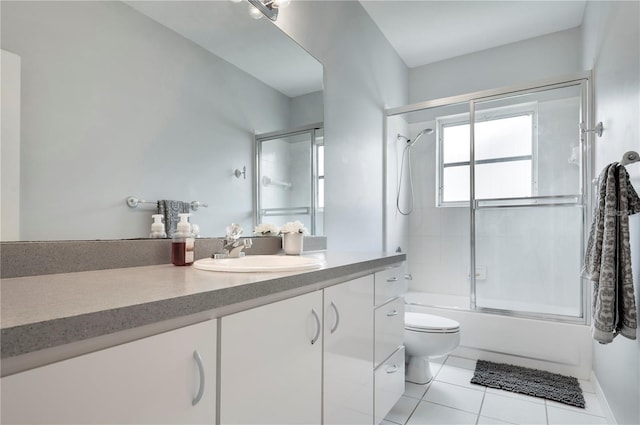 full bathroom featuring tile patterned flooring, toilet, vanity, and combined bath / shower with glass door