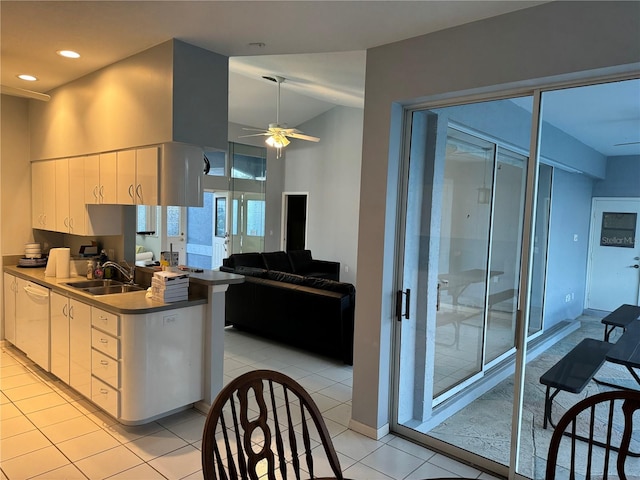 kitchen featuring light tile patterned flooring, sink, dishwasher, ceiling fan, and white cabinets