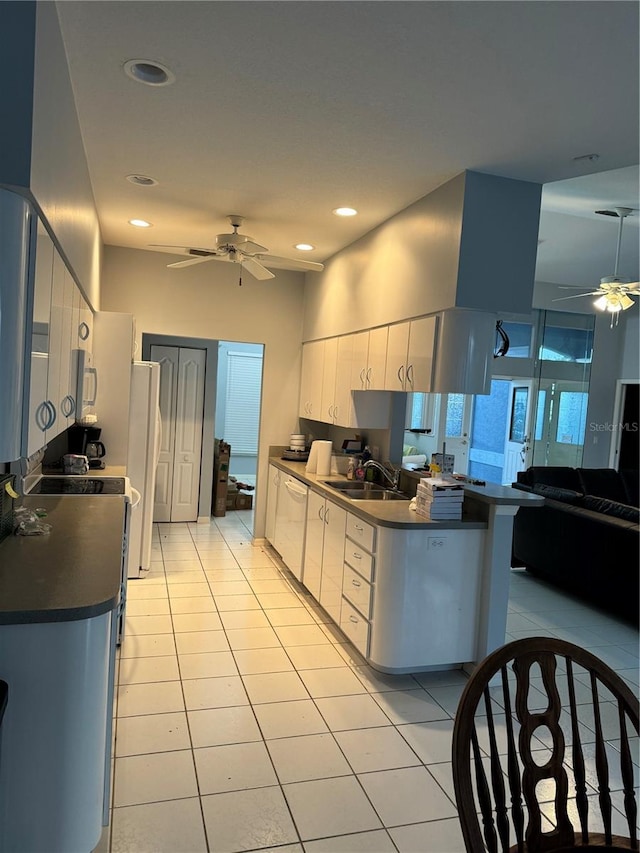 kitchen with light tile patterned floors, sink, white appliances, ceiling fan, and white cabinets