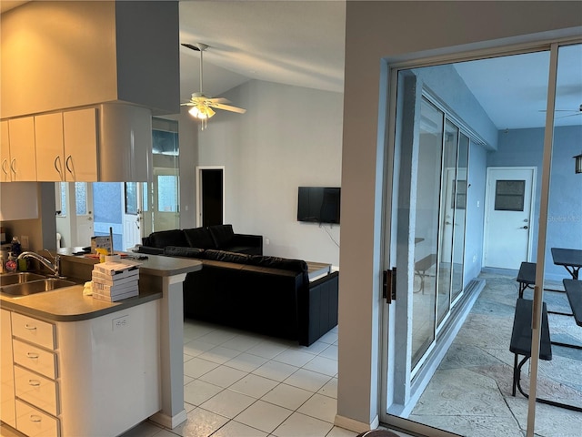 kitchen featuring sink, high vaulted ceiling, ceiling fan, and light tile patterned flooring