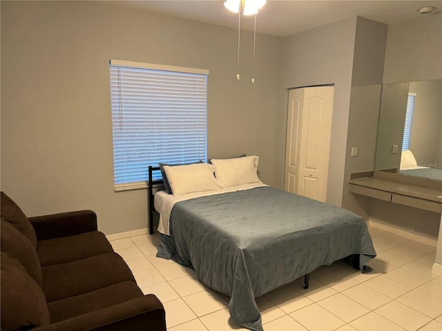 tiled bedroom with a closet