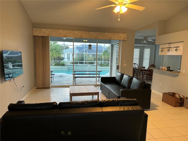 living room with ceiling fan, a healthy amount of sunlight, and light tile patterned floors