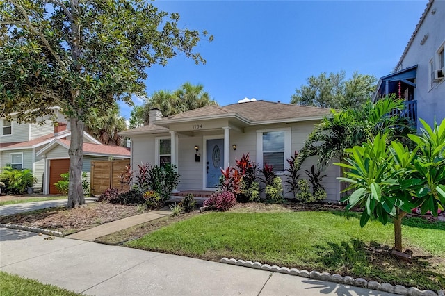 view of front of house with a front yard and a garage