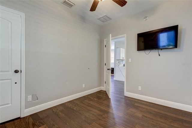 unfurnished bedroom featuring ceiling fan and dark hardwood / wood-style floors