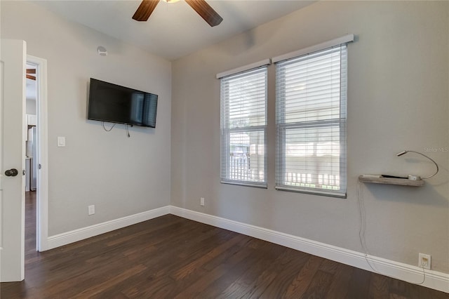 unfurnished living room with ceiling fan and dark hardwood / wood-style floors